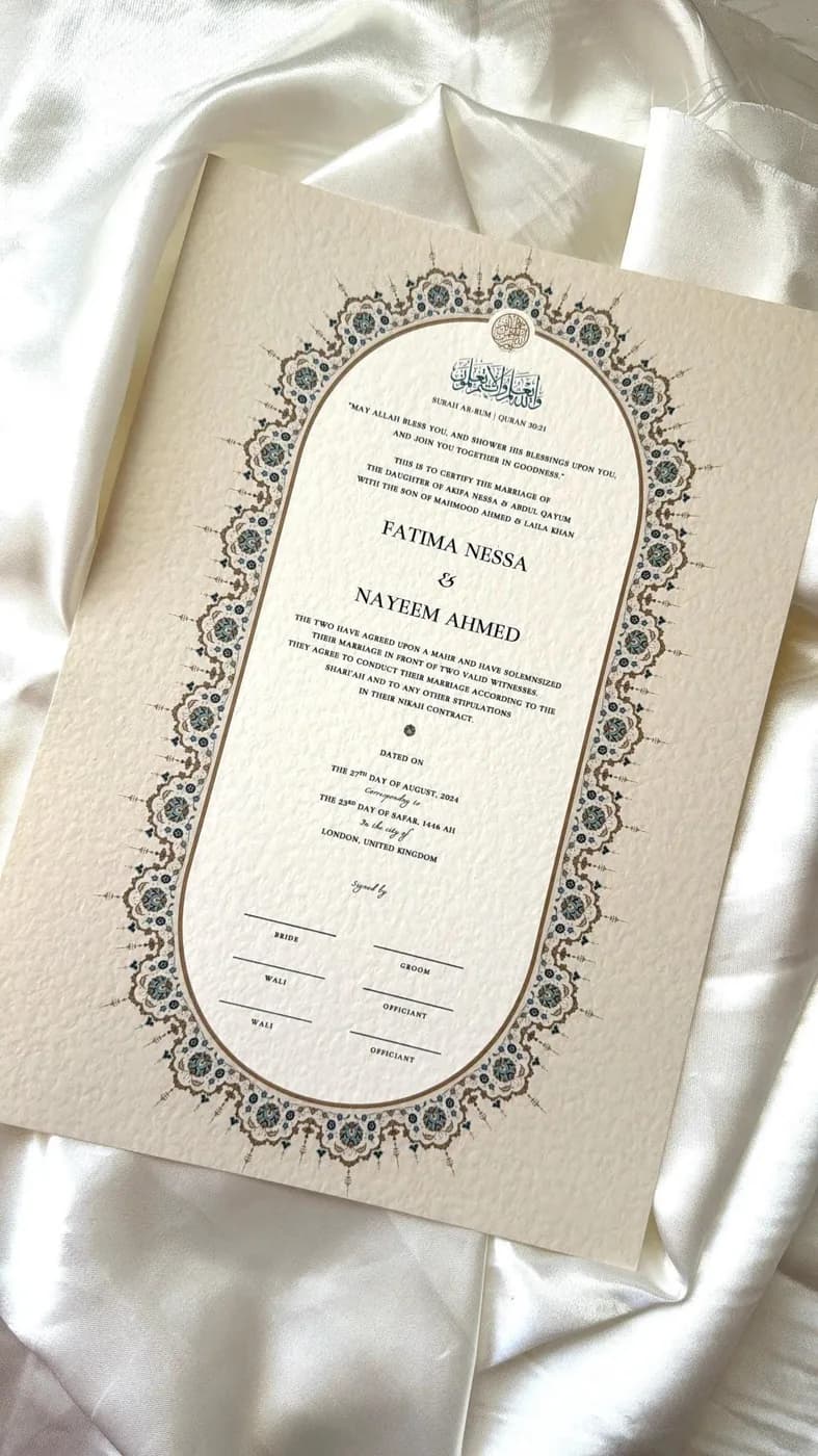 Qamar nikah certificate with an ivory oval arch and blue and gold floral border on cream card