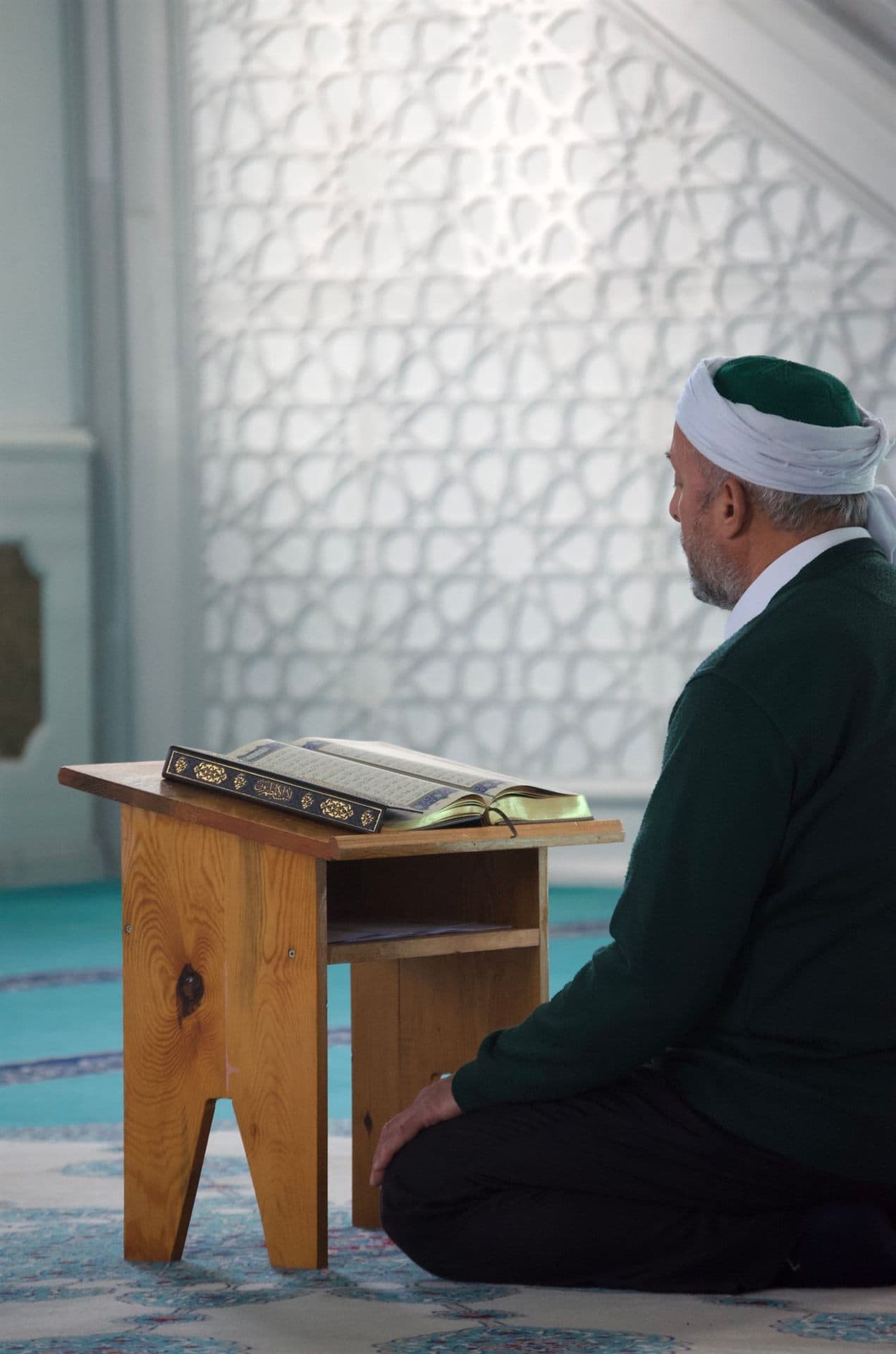 An imam reading the Quran in a mosque