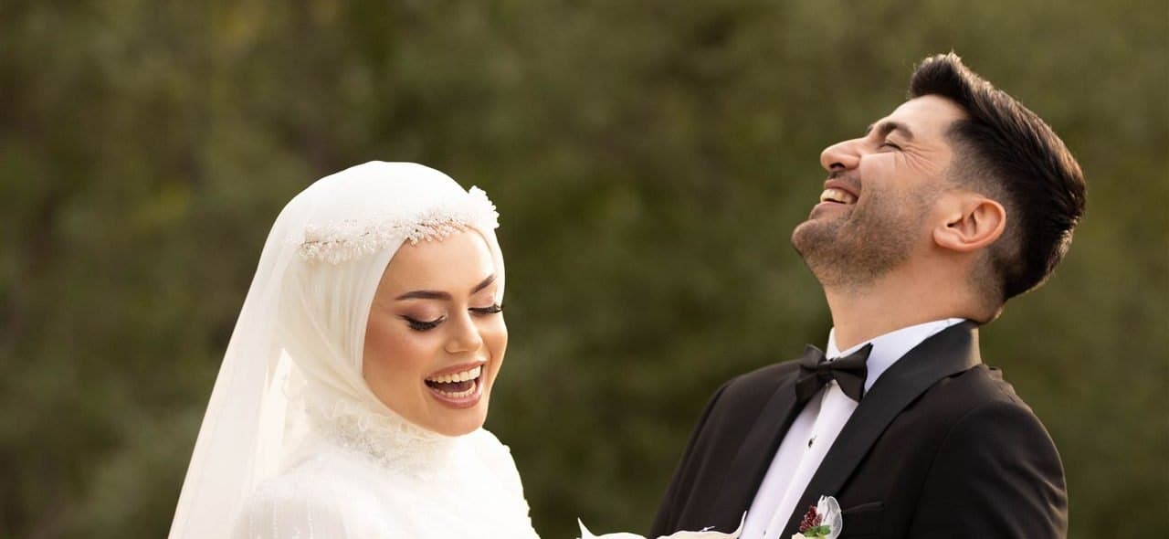 A smiling bride and groom on their nikah day